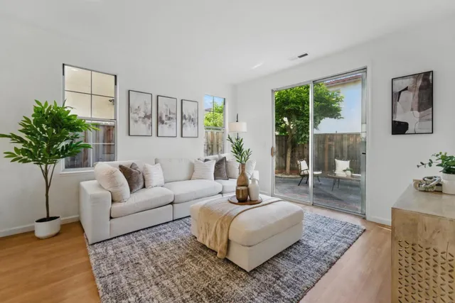 a living room with furniture and a potted plant