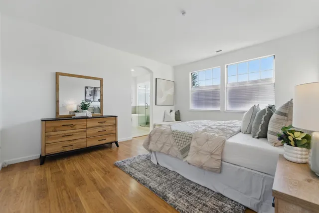 a bedroom with a bed and wooden floor