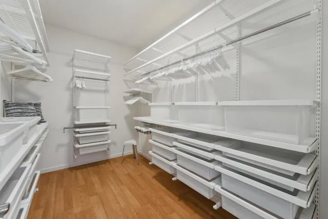 a view of walk in closet with empty racks