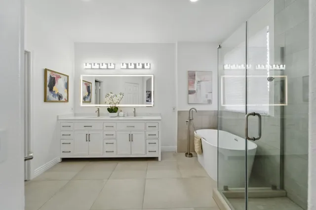 a bathroom with a granite countertop sink mirror and a shower