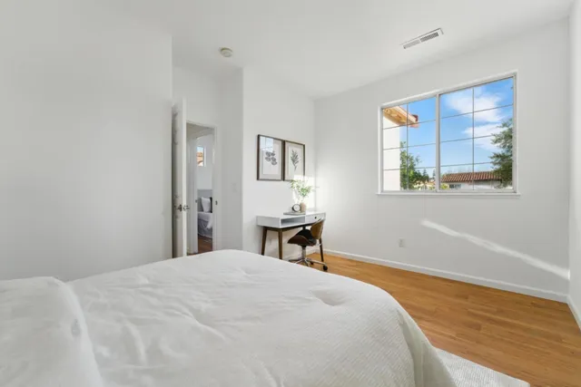 a bedroom with a bed and a table