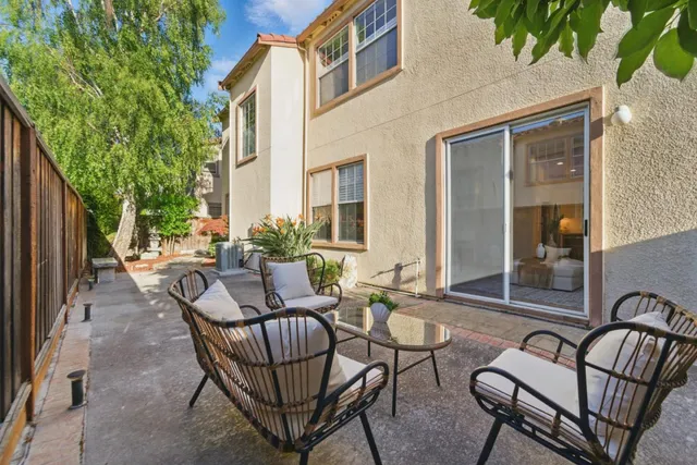a view of a patio with couple of chairs and a couch