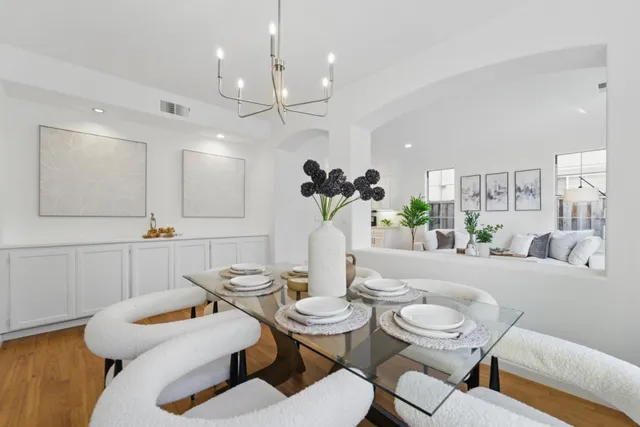 a dining room with furniture and a chandelier