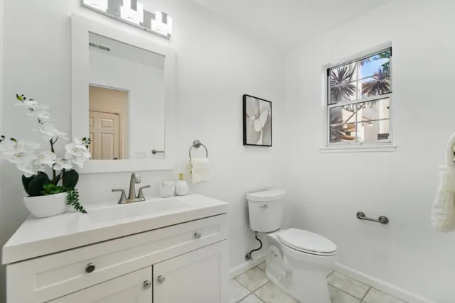 a bathroom with a sink mirror and toilet