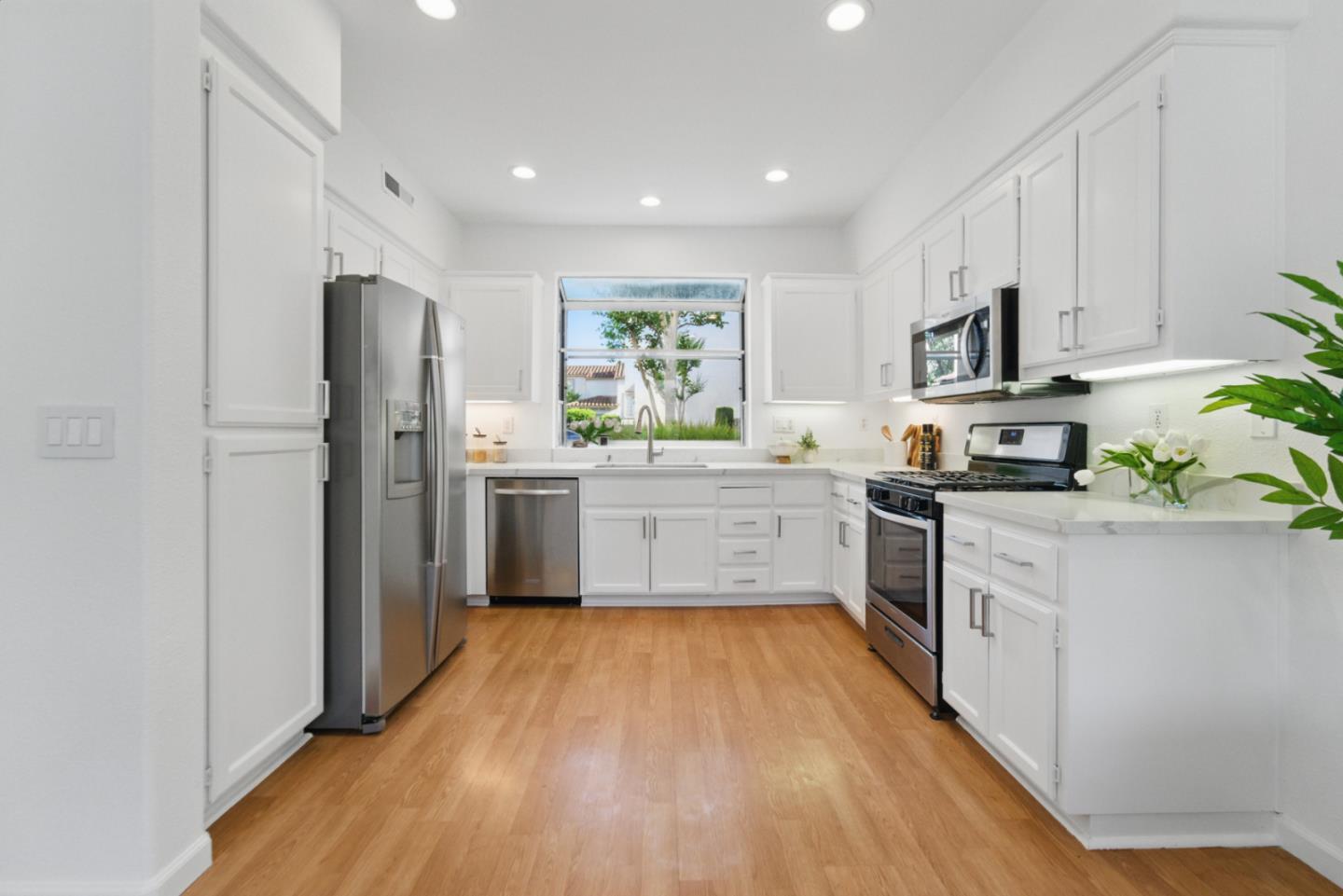 560 Villa Centre Way San Jose, CA 95128 - Photo 8 of 31 a kitchen with white cabinets and white appliances