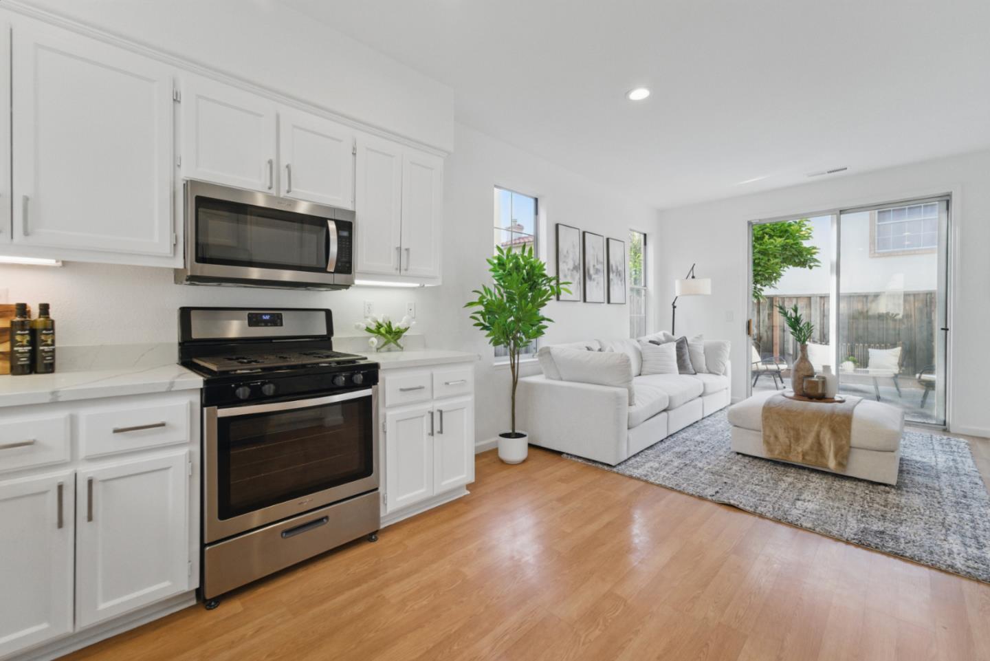 560 Villa Centre Way San Jose, CA 95128 - Photo 10 of 31 a kitchen with stainless steel appliances a stove a microwave a sink and cabinets