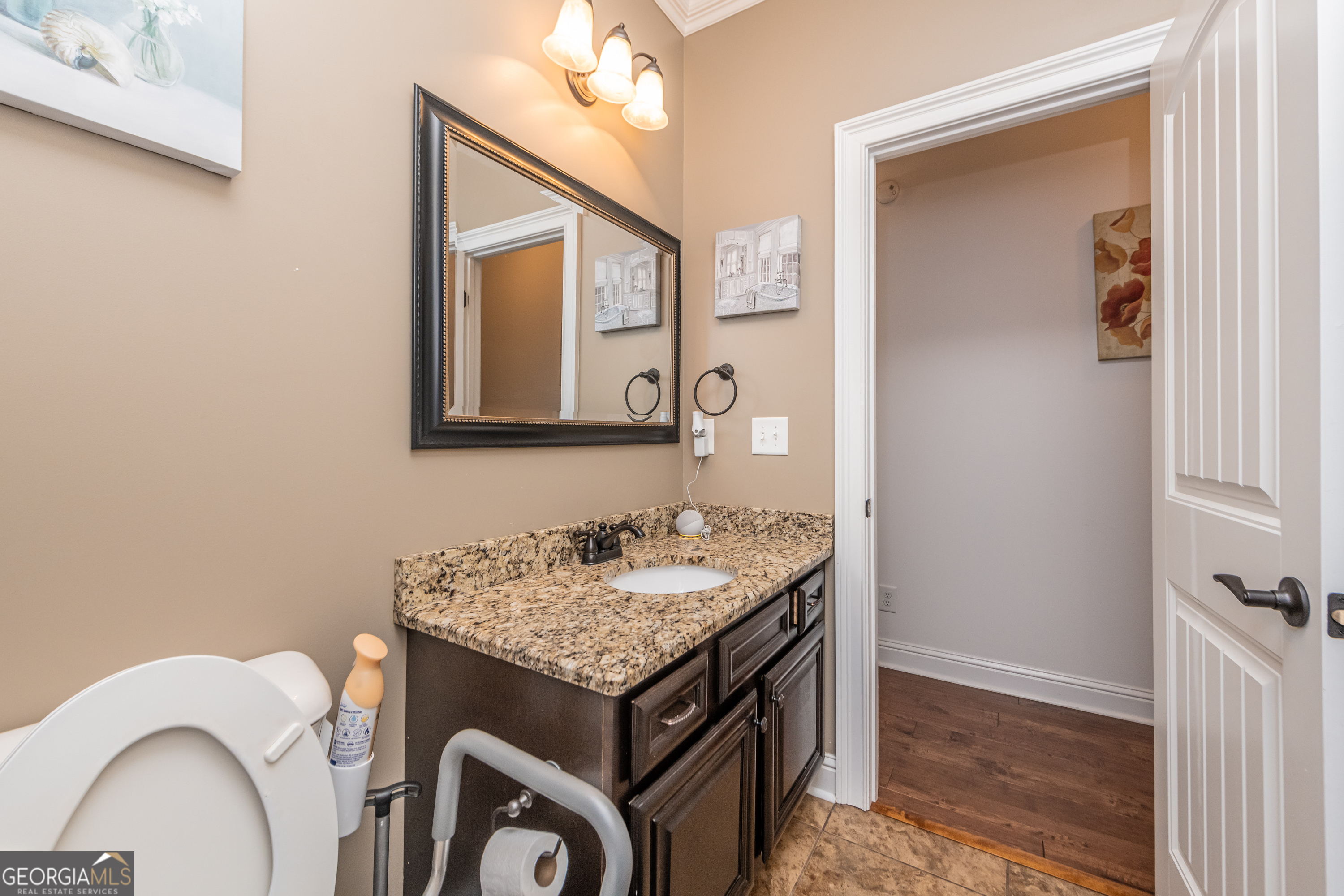 405 Old Bridge Road Warner Robins, GA 31088 - Photo 32 of 55 a bathroom with a granite countertop sink and a mirror