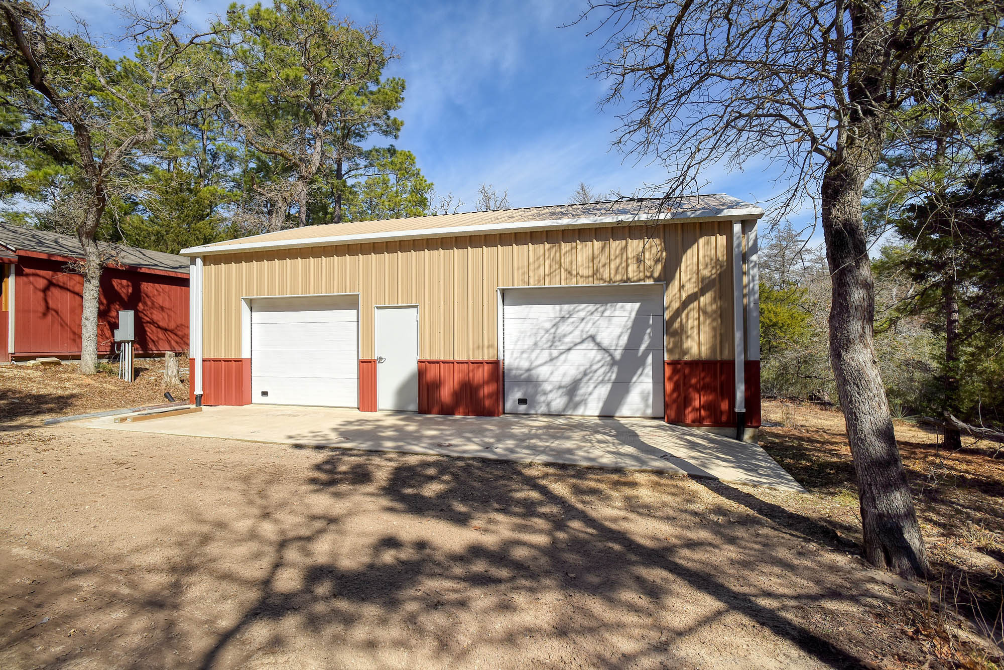 1024 Sand Hills Road Red Rock, TX 78662 - Photo 3 of 37 SHOP BUILDING
• Commercial-quality Red Iron shop building.
• Built on commercial-grade concrete slab.
• Fully insulated structure.
• Commercial garage door openers installed.
• Wiring only needs final completion.
• Sliding doors are insulated 3-inch doors.
• Live power already connected to building.