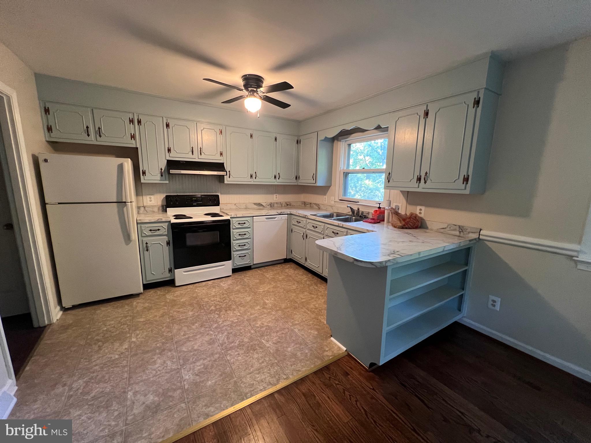 439 Ridgemore Street Fredericksburg, VA 22405 - Photo 7 of 17 a kitchen with a refrigerator sink and stove