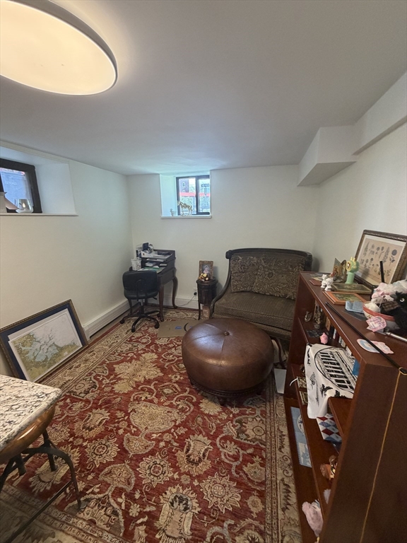32 Reedsdale Street, Unit D Boston, MA 02134 - Photo 2 of 4 a bedroom with a bed and wooden floor