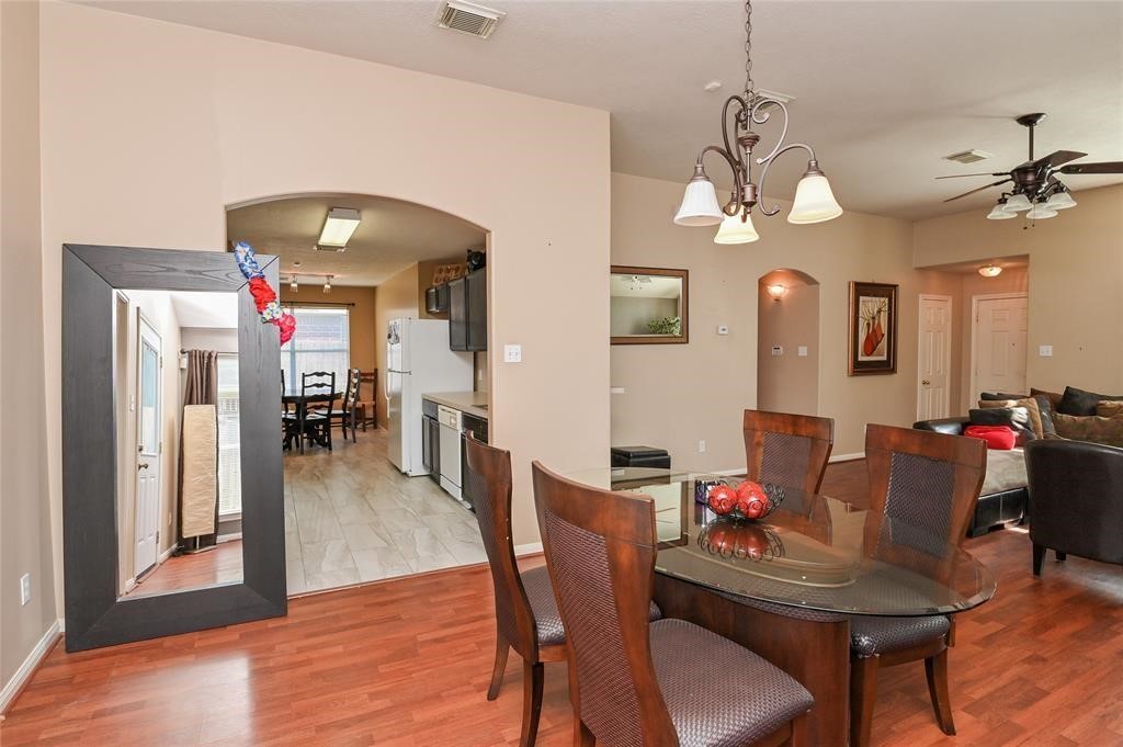 18446 South Wimbledon Drive Katy, TX 77449 - Photo 15 of 24 a view of a dining room with furniture and wooden floor