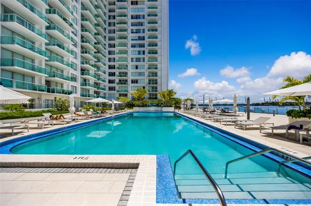 a swimming pool with outdoor seating and yard