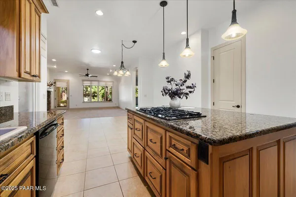 a kitchen with stainless steel appliances granite countertop a stove a sink a oven and a refrigerator with wooden floor