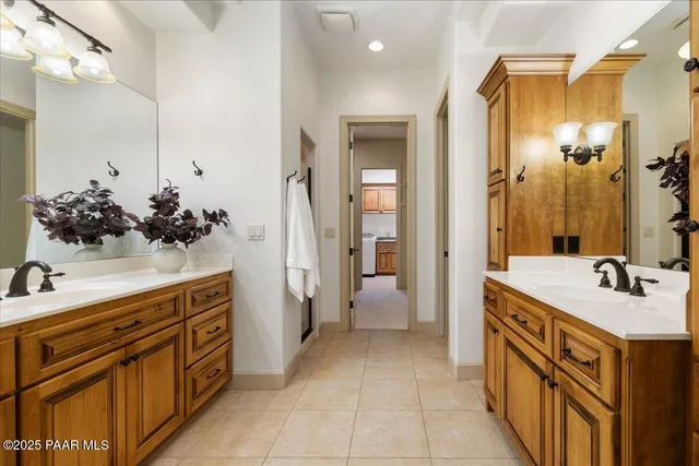 a spacious bathroom with a sink double vanity and a mirror