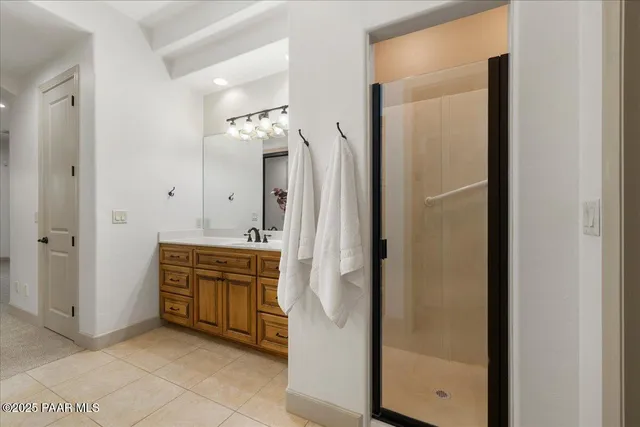 a spacious bathroom with a mirror and a shower