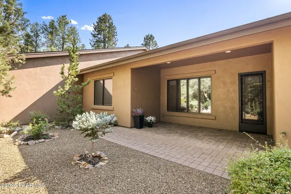 a view of a house with a yard covered in snow