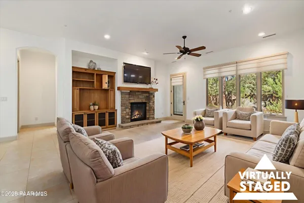 a living room with furniture a fireplace and a chandelier