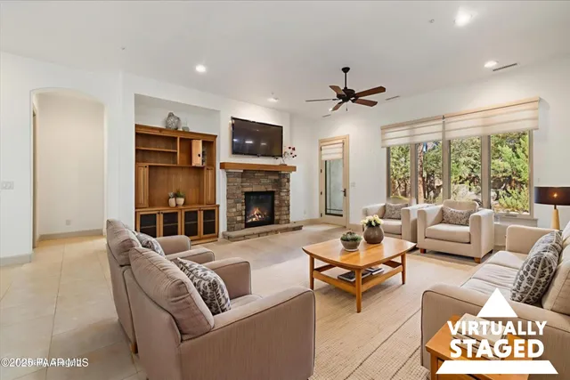 a living room with furniture a fireplace and a chandelier