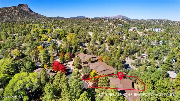 an aerial view of a house with a yard and garden