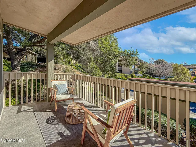 a balcony with chairs and with wooden floor