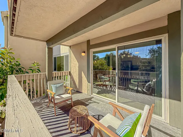 a bedroom with a bed couch and window