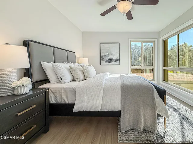 a bedroom with bed couch and window