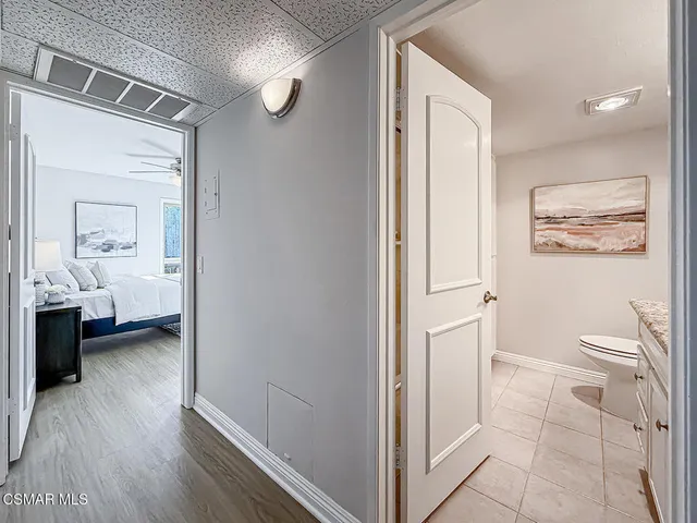a bathroom with a granite countertop toilet a sink and a mirror