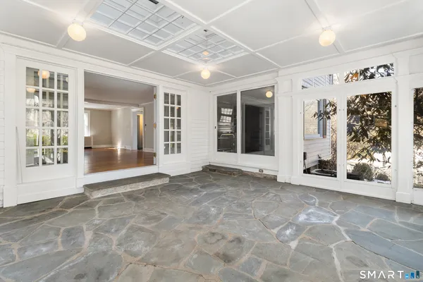 wooden floor fireplace and windows in an empty room