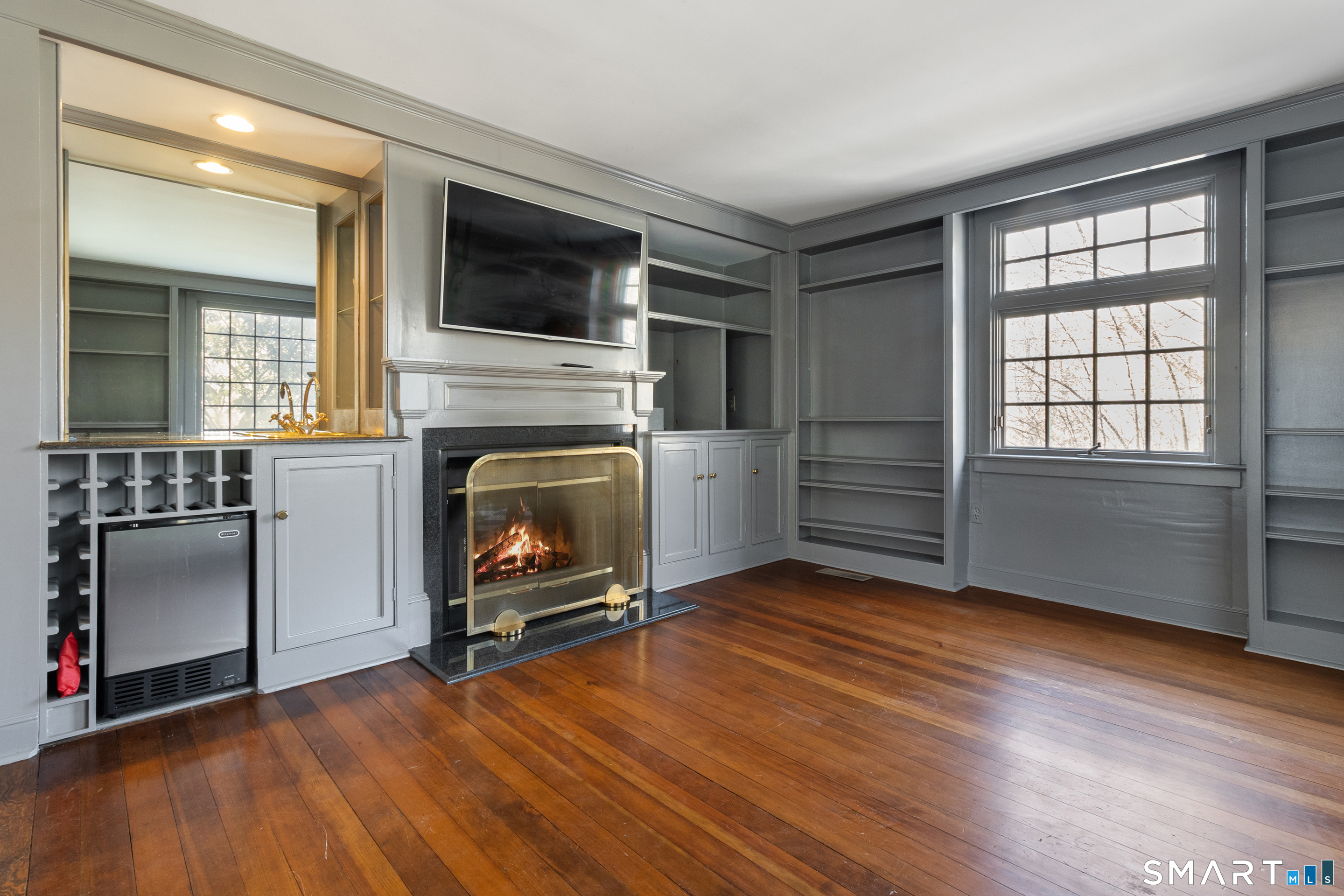 145 Lyons Plain Road Weston, CT 06883 - Photo 14 of 33 wooden floor fireplace and windows in an empty room
