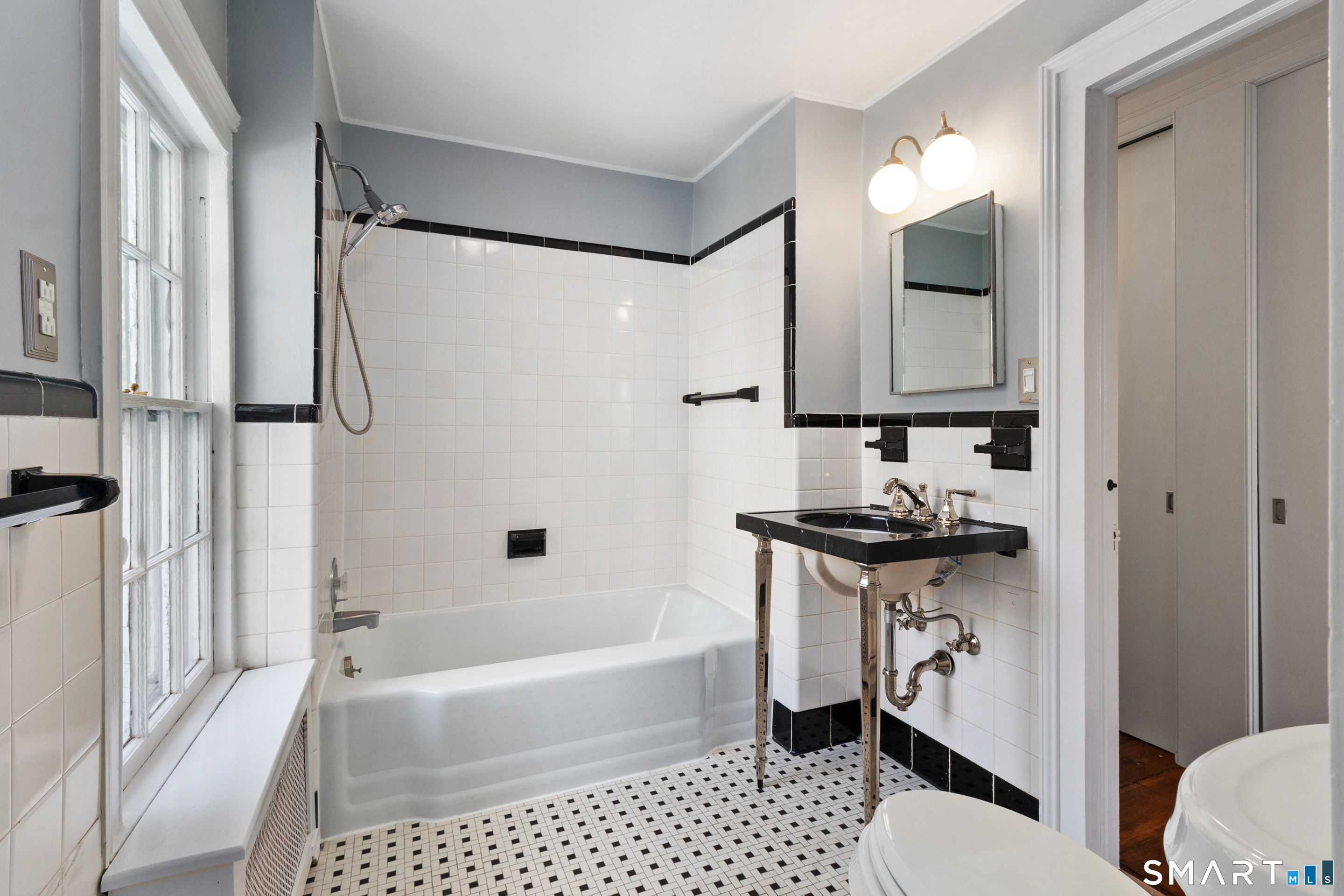 145 Lyons Plain Road Weston, CT 06883 - Photo 25 of 33 a bathroom with a sink a mirror toilet and bathtub