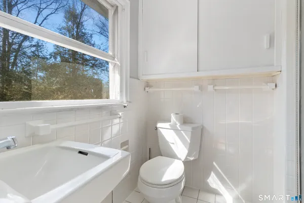 a bathroom with a sink toilet and mirror