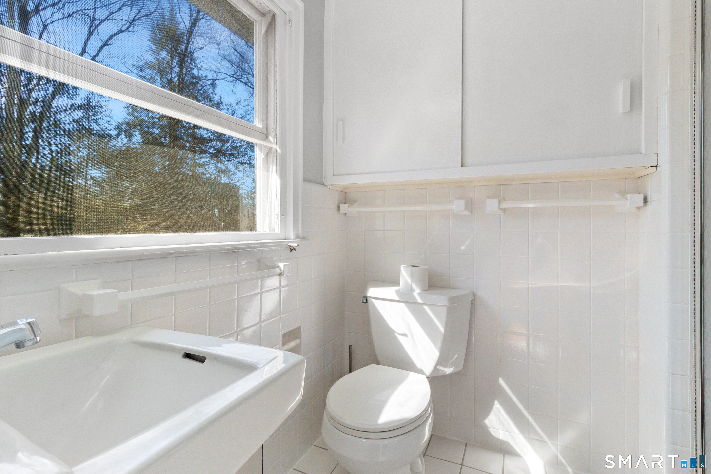 145 Lyons Plain Road Weston, CT 06883 - Photo 28 of 33 a white toilet sitting next to a bathroom sink