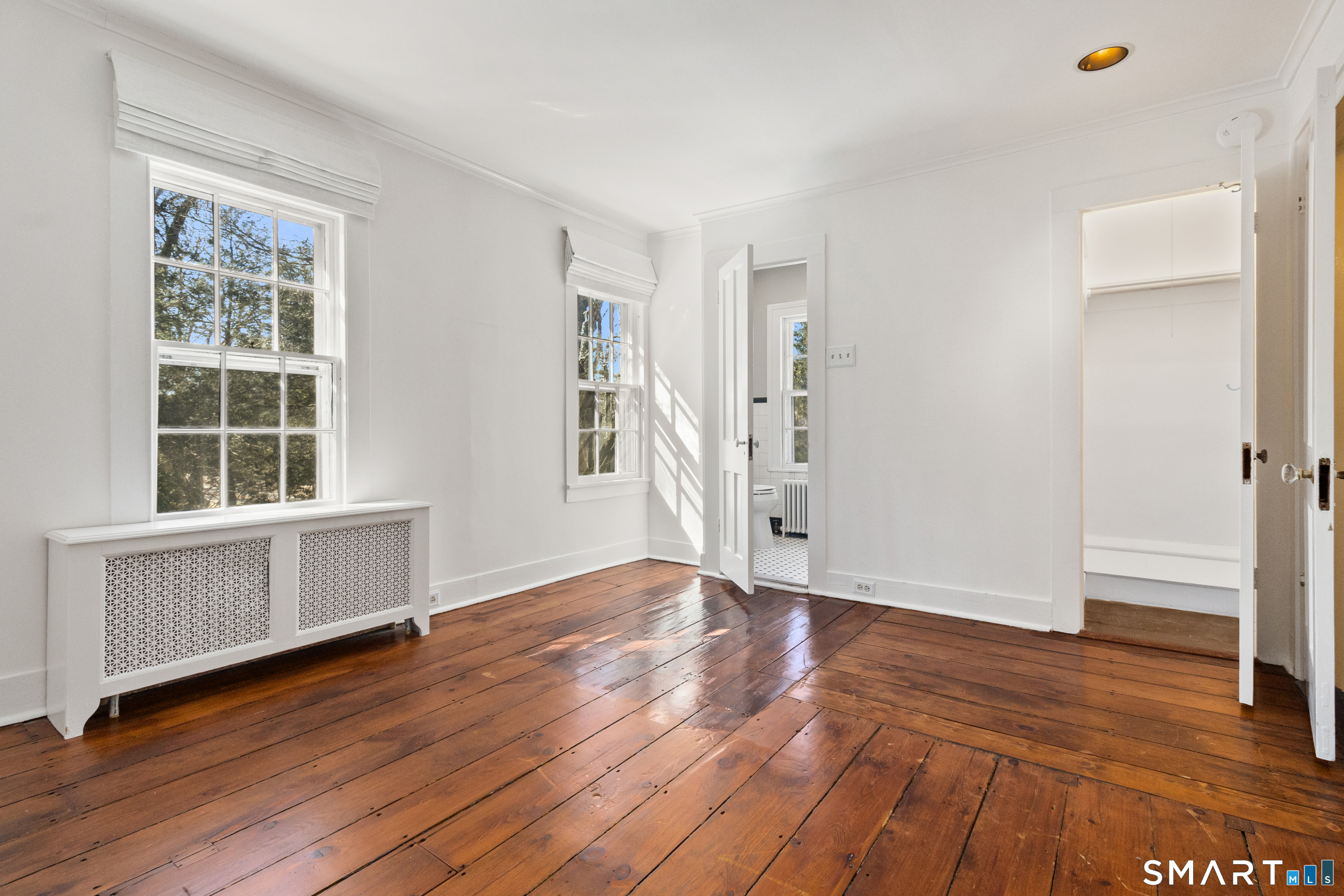 145 Lyons Plain Road Weston, CT 06883 - Photo 29 of 33 an empty room with wooden floor and windows