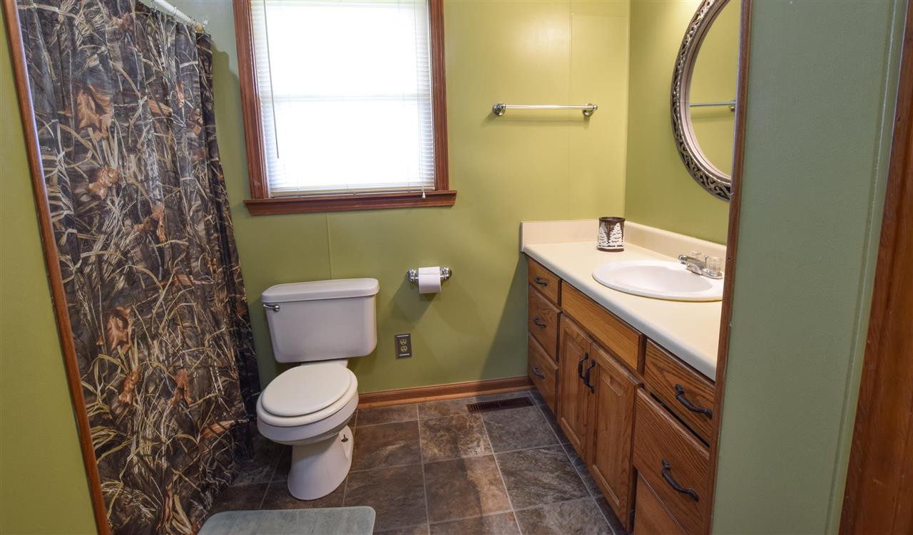 947 South Wolverine Road Troy, TN 38260 - Photo 15 of 20 a bathroom with a granite countertop toilet sink and mirror