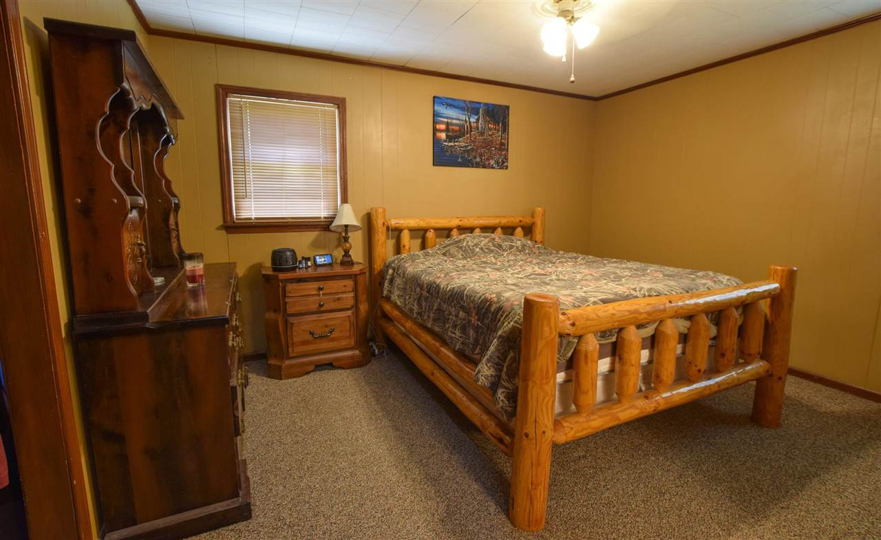 947 South Wolverine Road Troy, TN 38260 - Photo 16 of 20 a bedroom with a bed next to a window