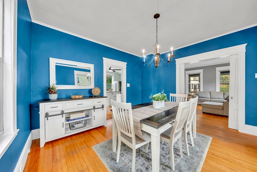 7 Melrose Street Amesbury, MA 01913 - Photo 11 of 34 a dining room with furniture a chandelier and wooden floor