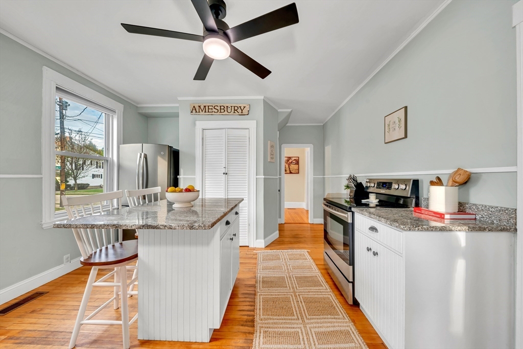 7 Melrose Street Amesbury, MA 01913 - Photo 12 of 34 a kitchen with stainless steel appliances granite countertop a sink and dishwasher