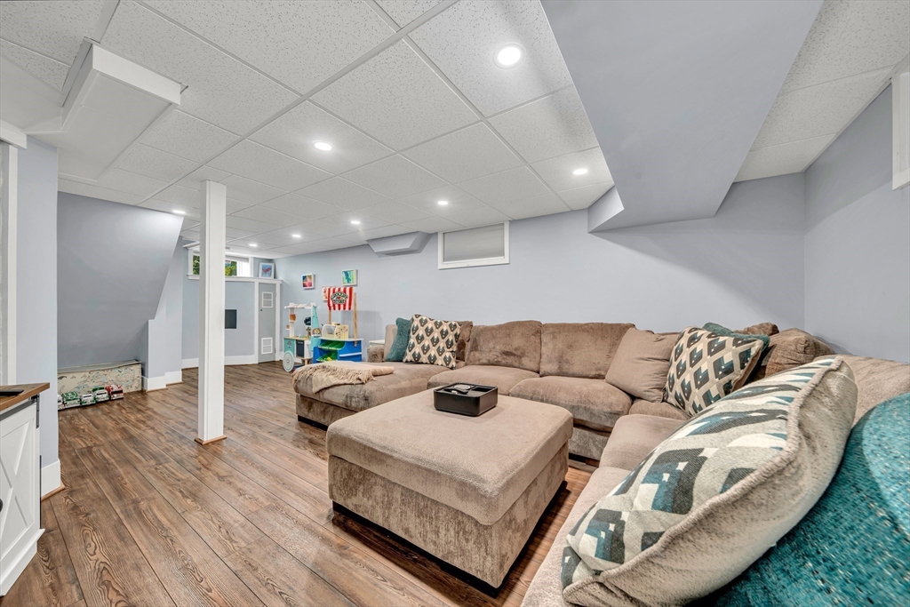 7 Melrose Street Amesbury, MA 01913 - Photo 27 of 34 a living room with furniture and a wooden floor