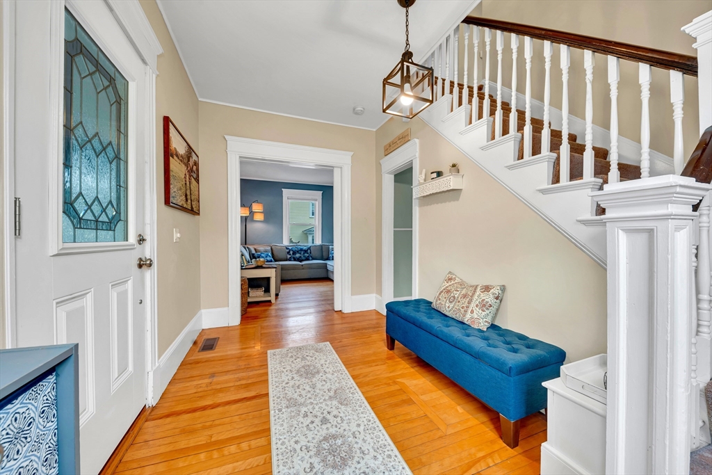 7 Melrose Street Amesbury, MA 01913 - Photo 5 of 34 a hallway with wooden floor and furniture