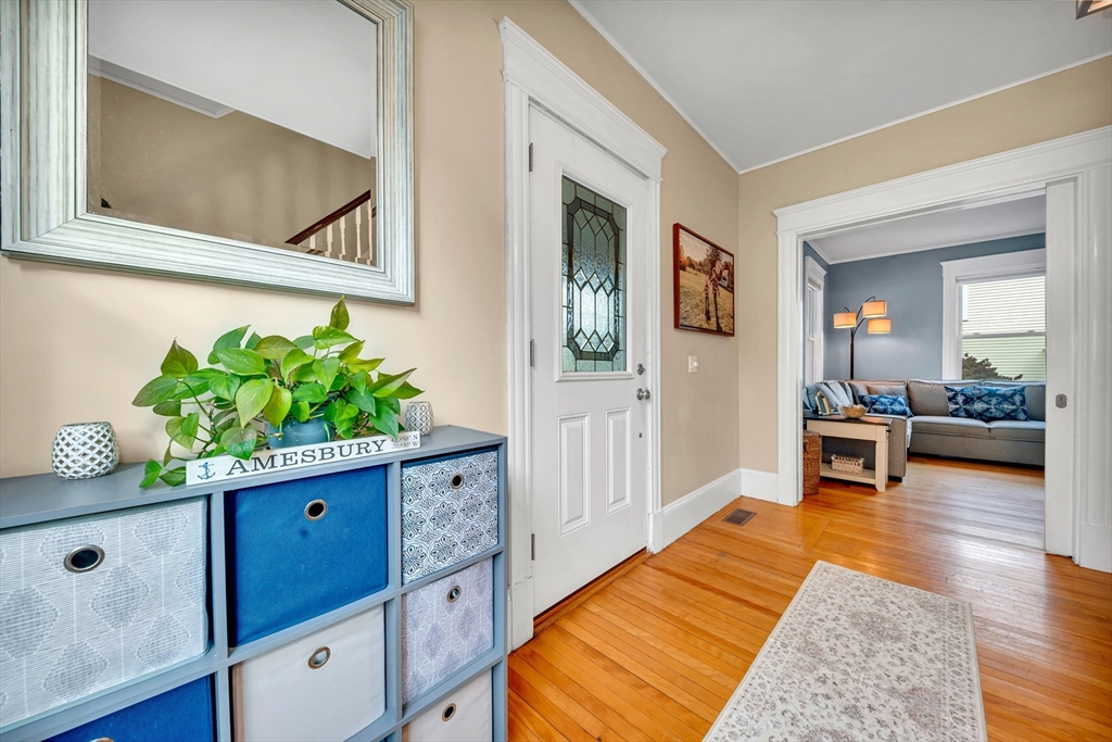 7 Melrose Street Amesbury, MA 01913 - Photo 6 of 34 a living room with a potted plant on the kitchen counter and stove