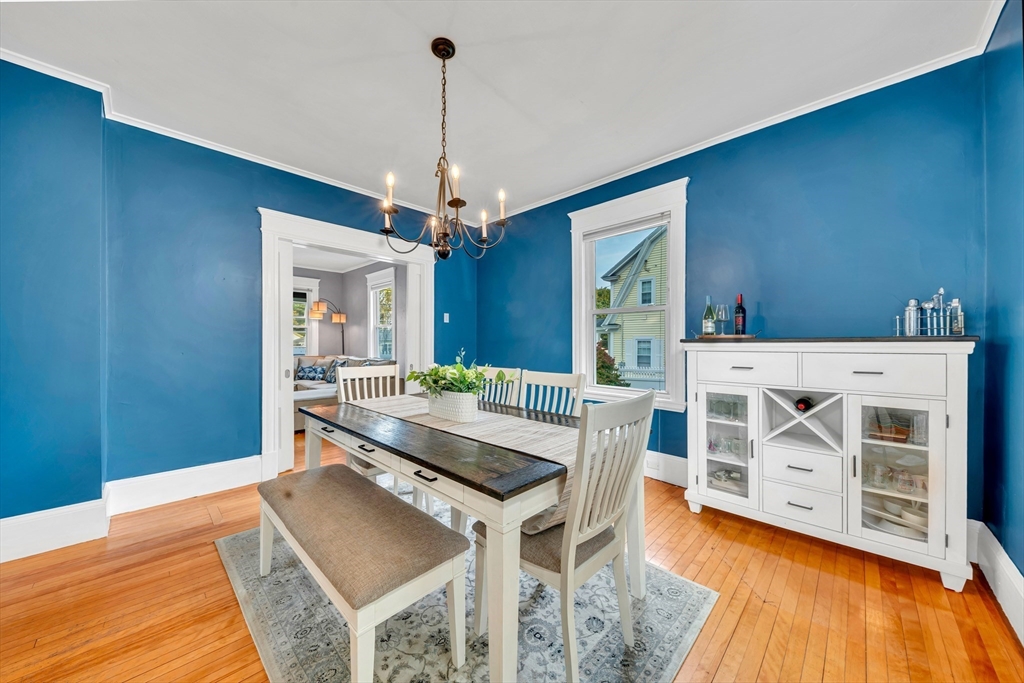 7 Melrose Street Amesbury, MA 01913 - Photo 10 of 34 a living room with a table chairs and a wooden floors