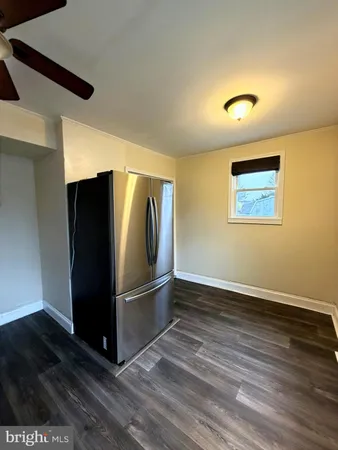 a view of a refrigerator in kitchen and wooden floor