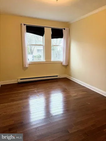 a view of wooden floor and windows in a room