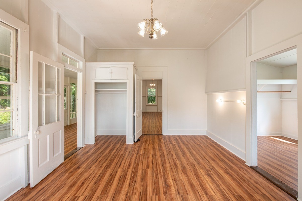 48-5314 Kukuihaele Road Honokaa, HI 96727 - Photo 13 of 24 a view of a room with wooden floor chandeliers and kitchen view
