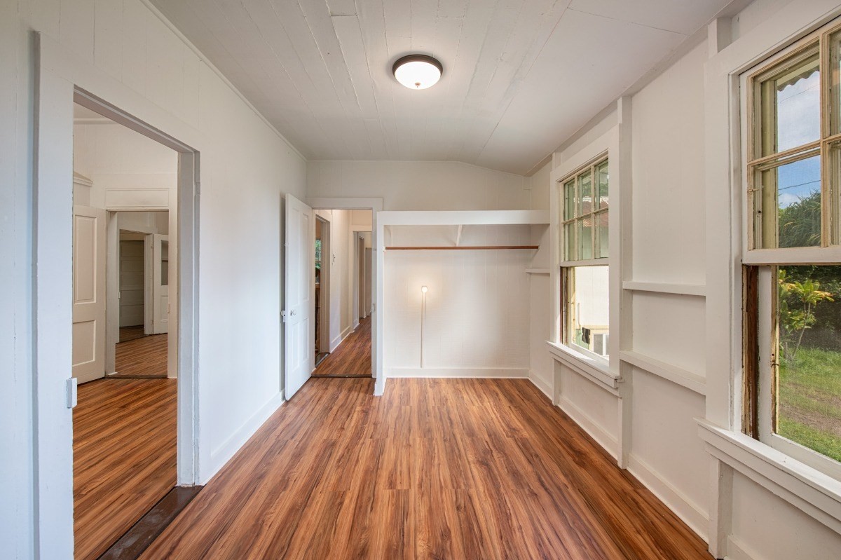 48-5314 Kukuihaele Road Honokaa, HI 96727 - Photo 14 of 24 a view of a room with wooden floor a ceiling fan and windows