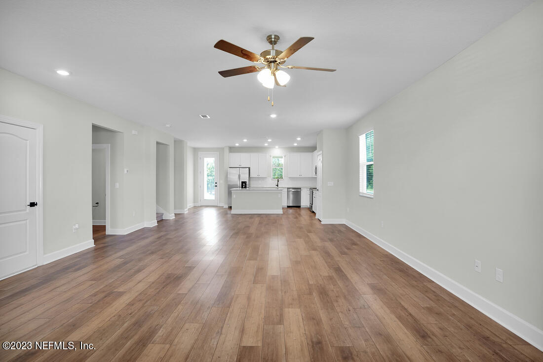 1074 Morgans Treasure Road St. Augustine, FL 32084 - Photo 4 of 11 a view of empty room with wooden floor and ceiling fan