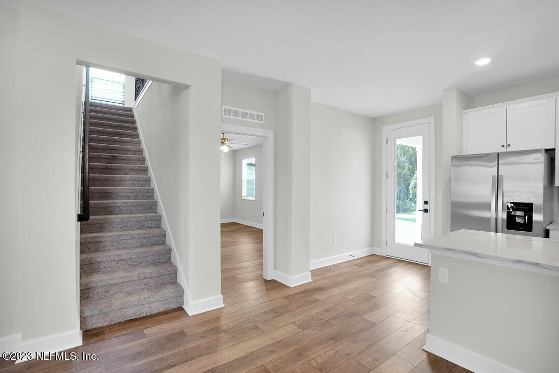 1074 Morgans Treasure Road St. Augustine, FL 32084 - Photo 6 of 11 a view of a kitchen with wooden floor and electronic appliances