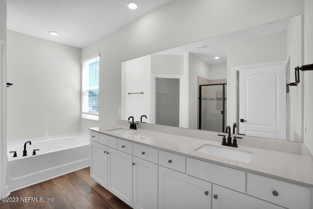 1074 Morgans Treasure Road St. Augustine, FL 32084 - Photo 9 of 11 a bathroom with a tub sink and mirror