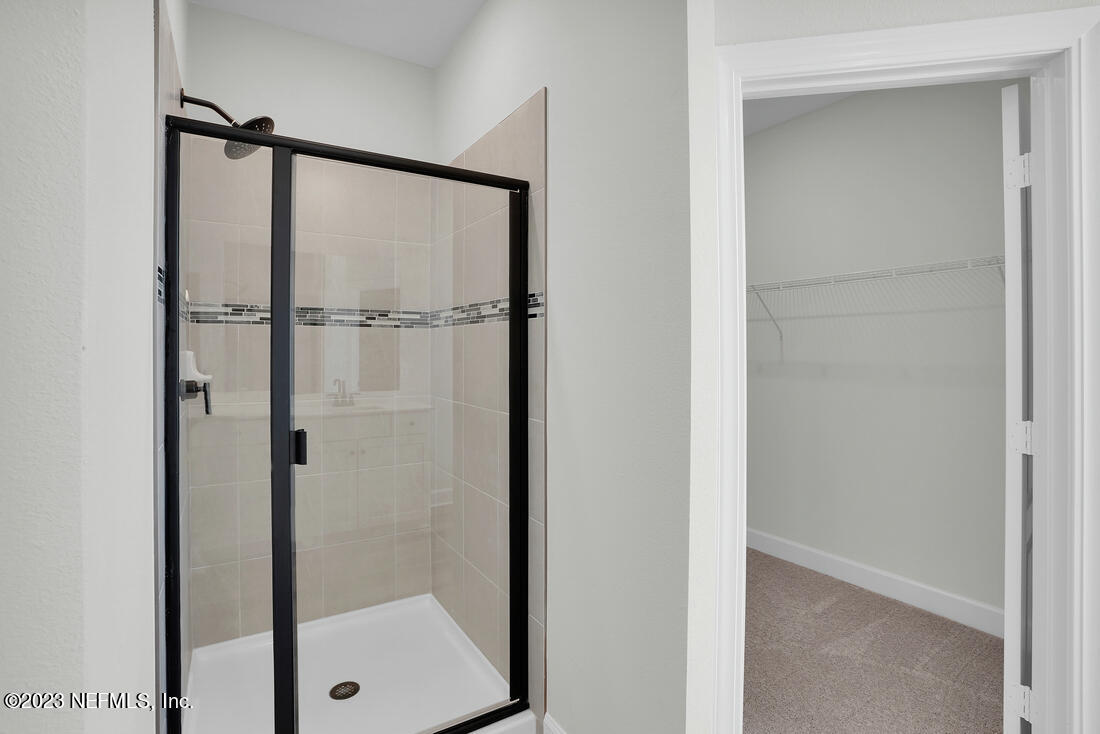 1074 Morgans Treasure Road St. Augustine, FL 32084 - Photo 10 of 11 a bathroom with a glass shower door