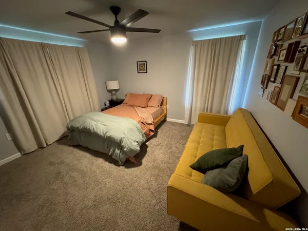 a spacious bedroom with a bed and a chandelier